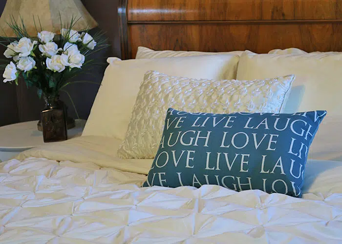 Live laugh Love pillow on the Corner room bed